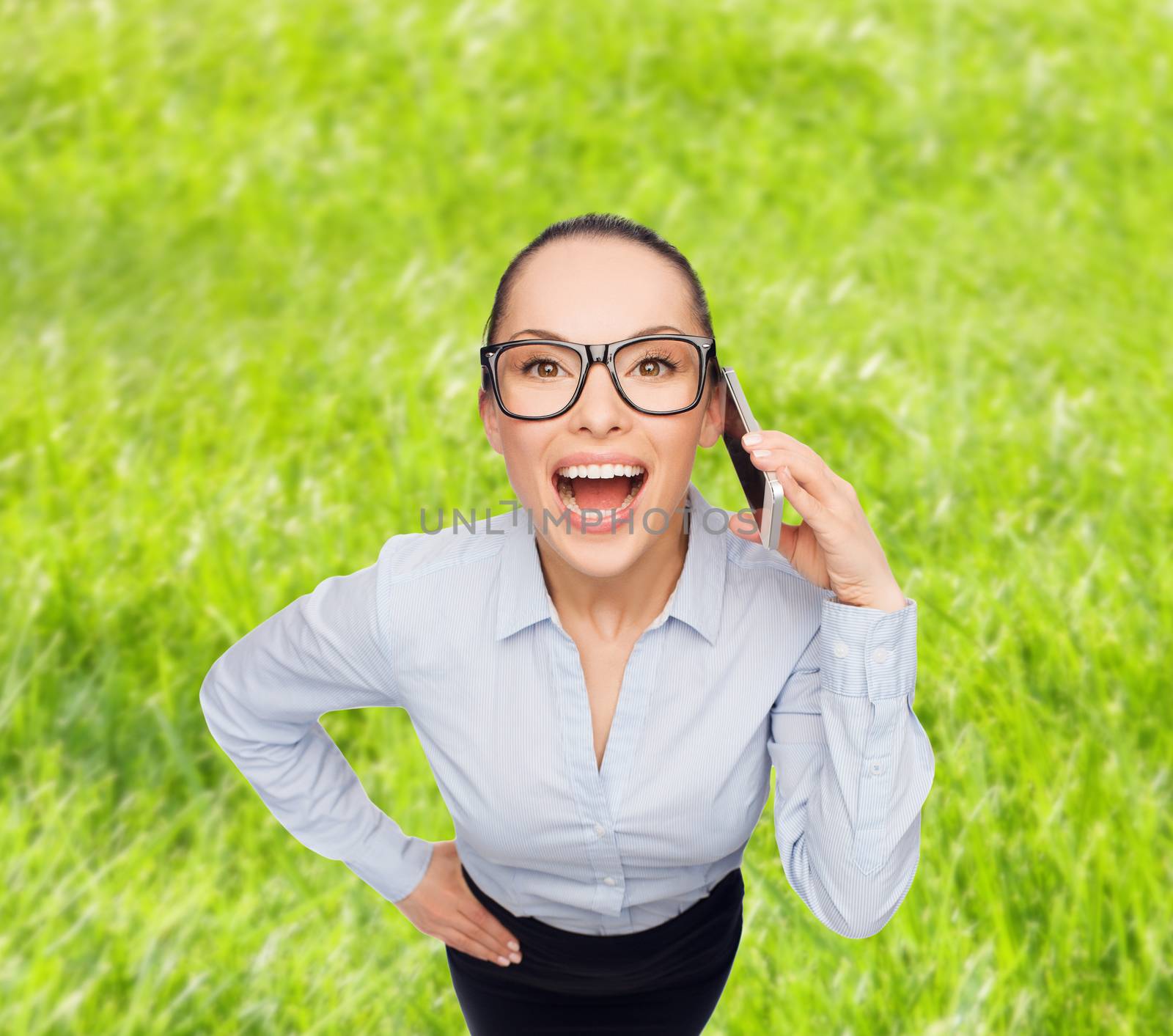 business, technilogy, communication and office concept - businesswoman in eyeglasses with smartphone talking to someone