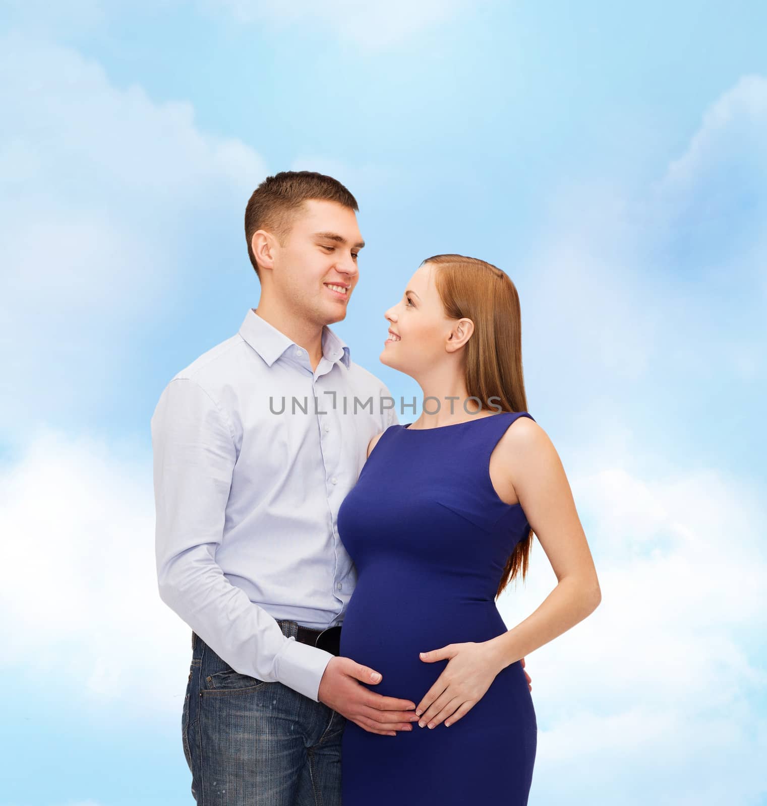 happy young family expecting child by dolgachov