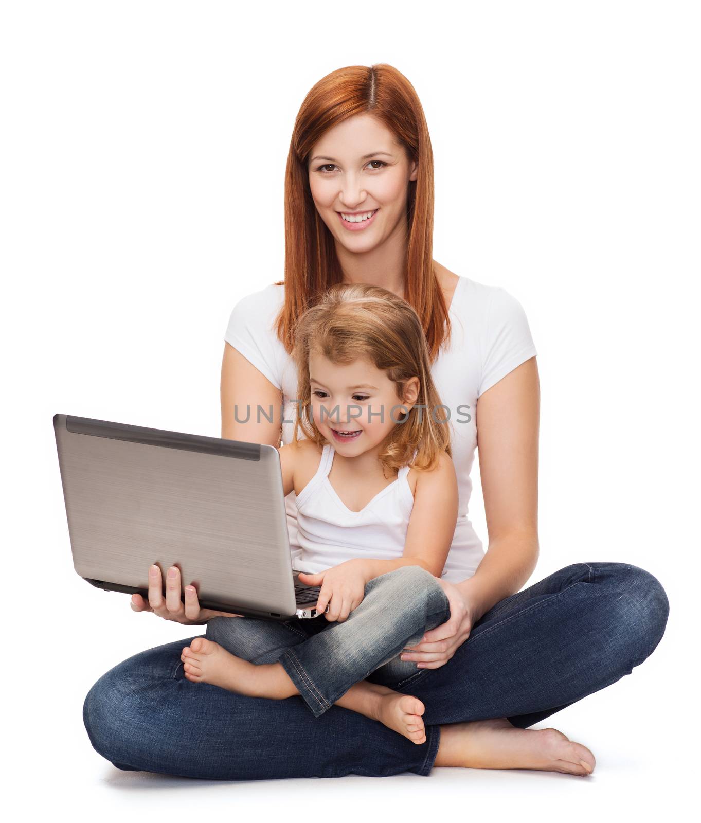 happy mother with adorable little girl and laptop by dolgachov