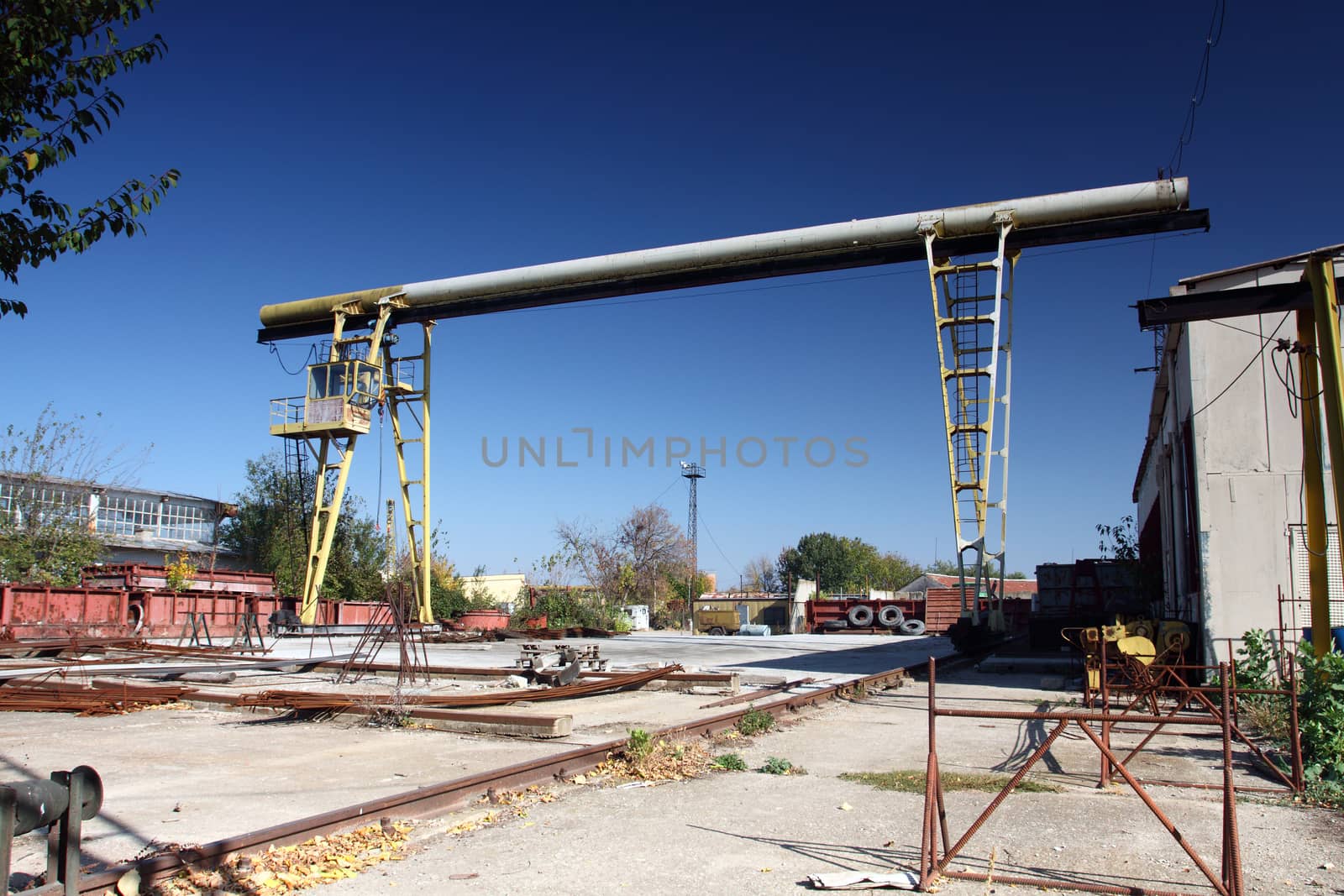 old yellow gantry crane, view from industrial yard