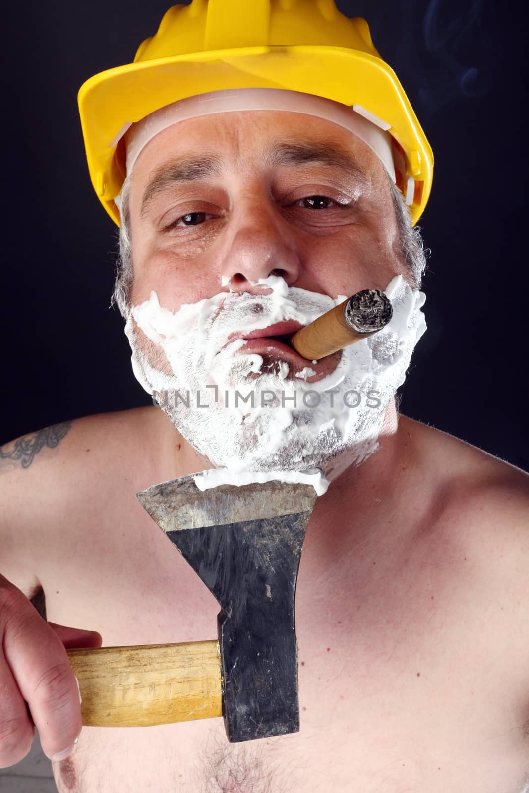 man with helmet and cigar shave himself with an ax