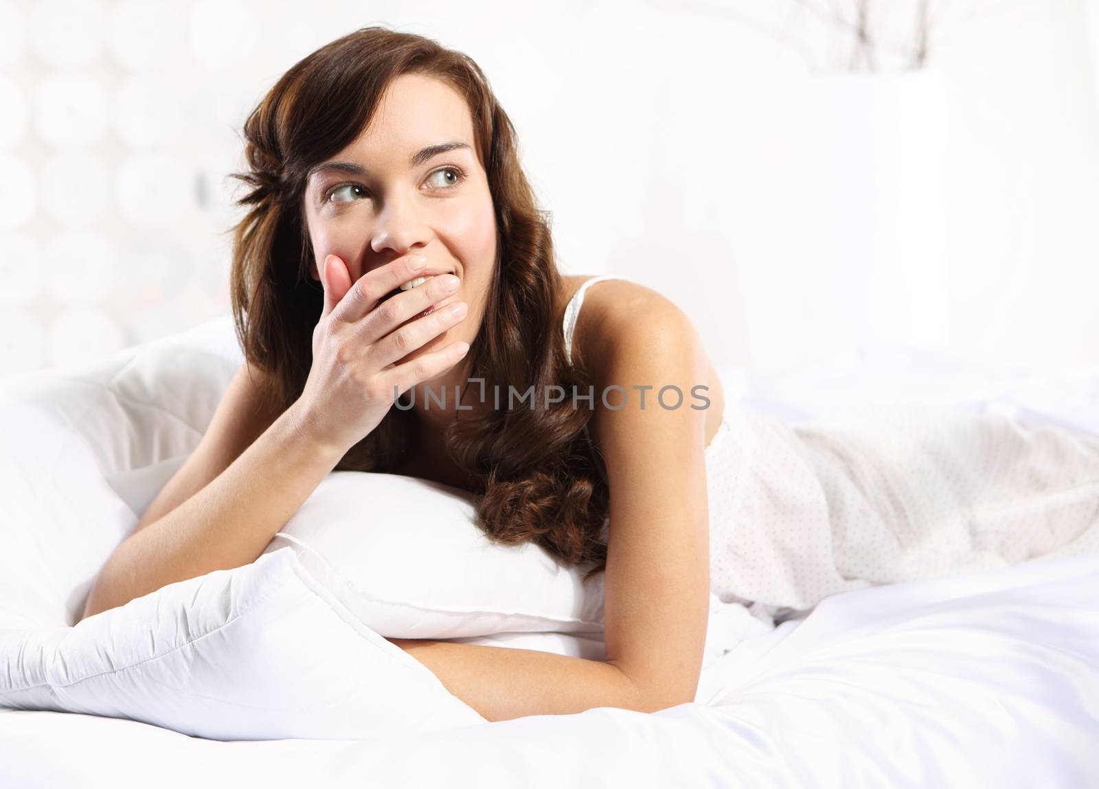 Young girl is resting in a white linen dressed romantic pajamas