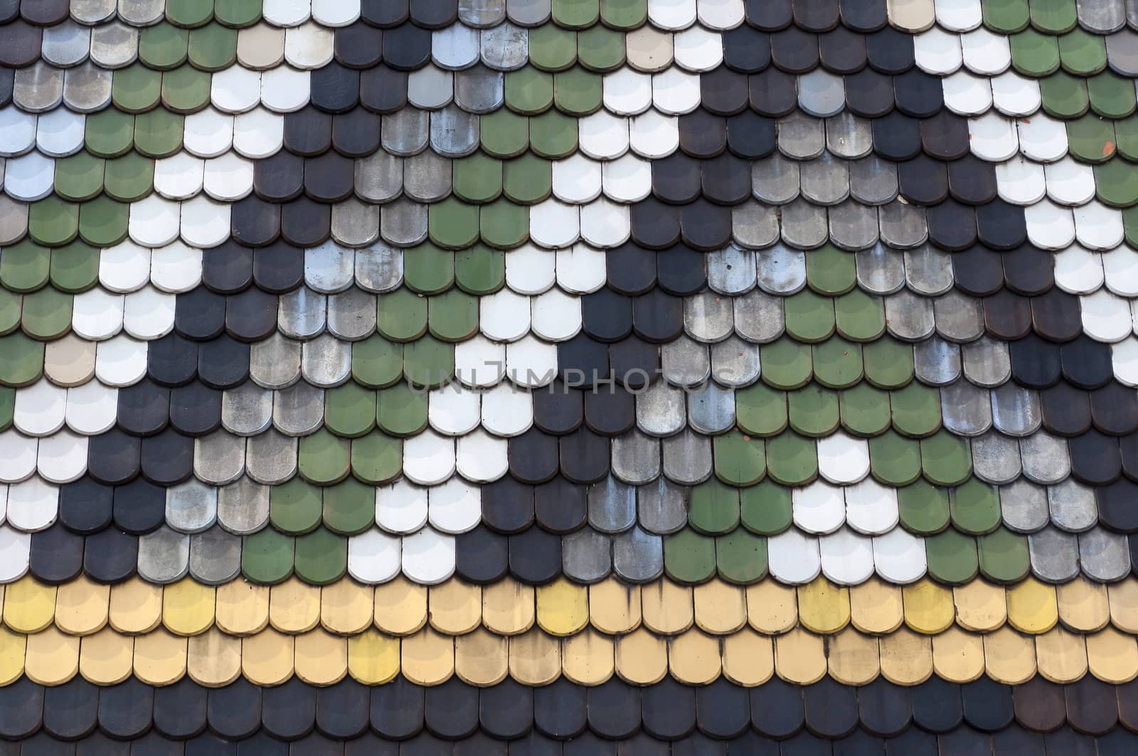 Detailed view of colorful wooden roof shingles.
