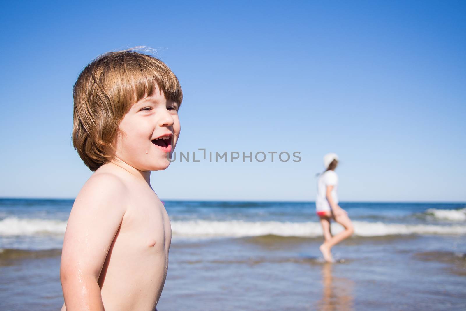 Kids playing in the water at the sea