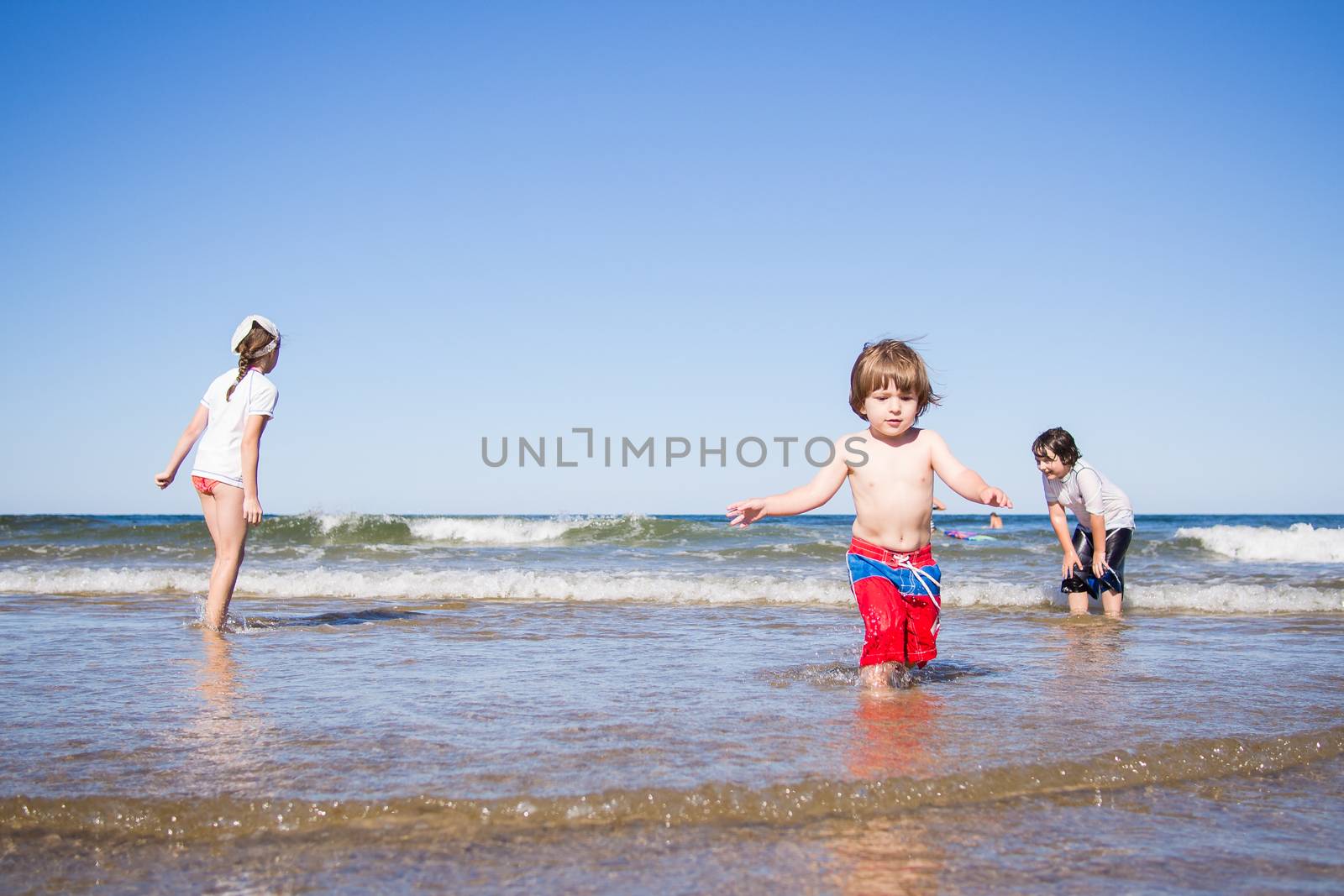 Kids playing in the sea by Talanis