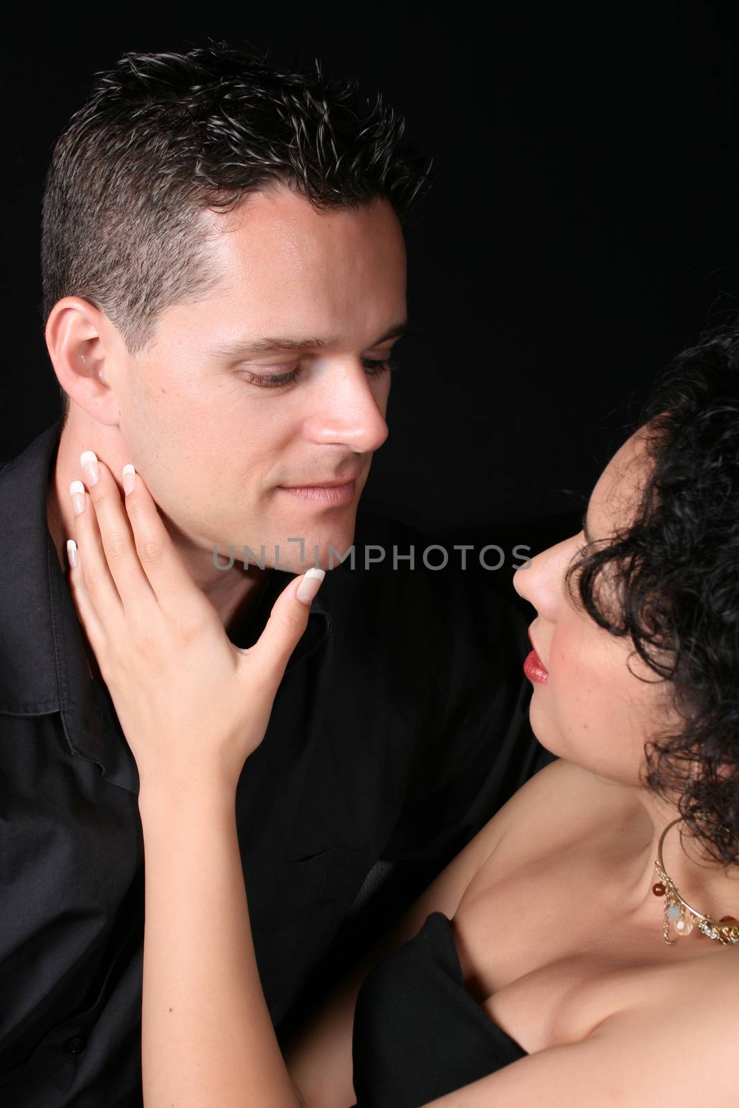 Loving couple against black background male looking down