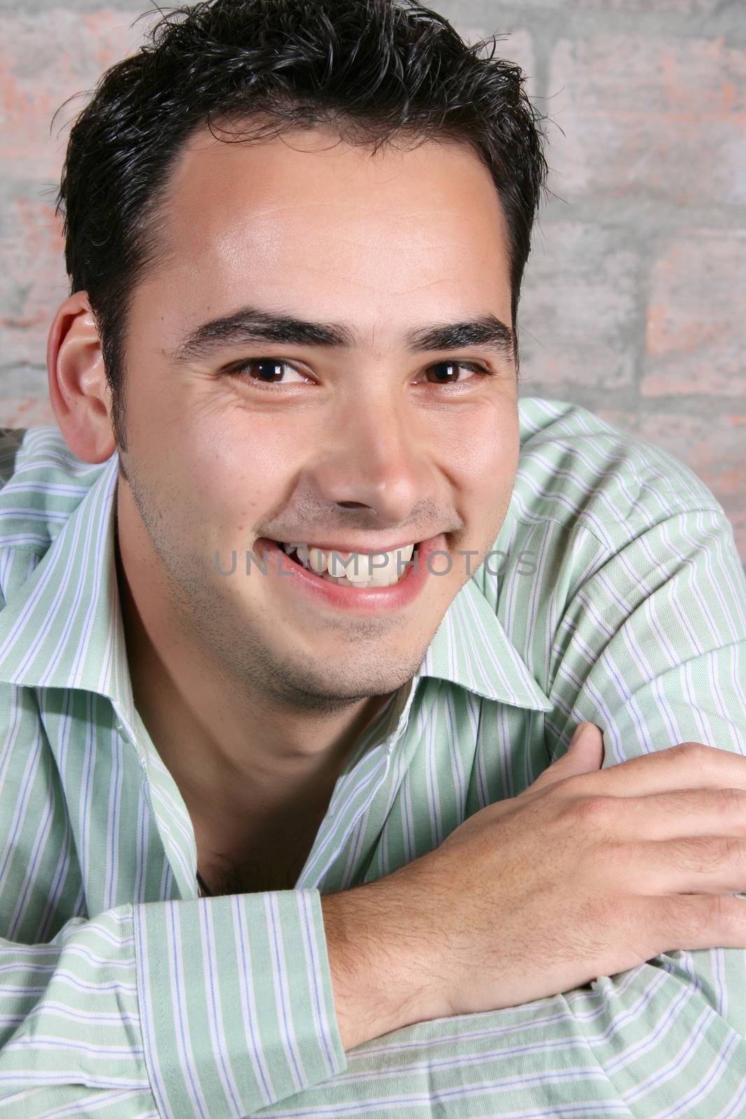 Brunette male model against a brickwall background