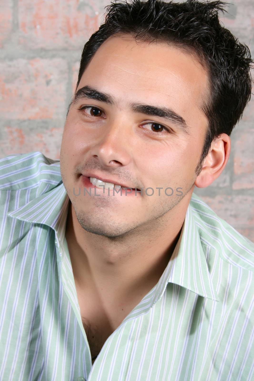 Brunette male model against a brickwall background