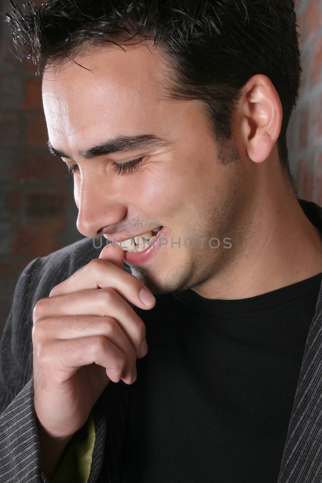 Brunette male model against a brickwall background