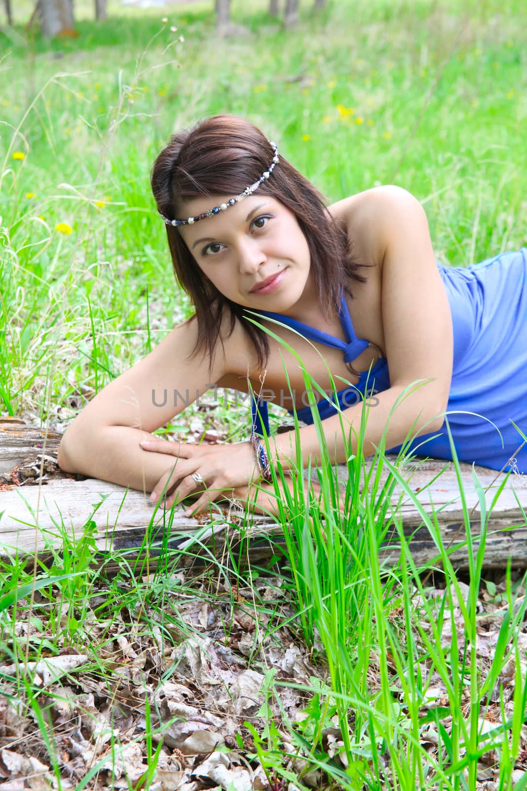 Brunette female wearing a blue dress outdoors