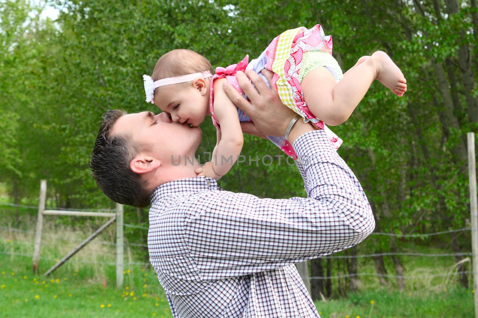 Father and daughter playing outside on the farm