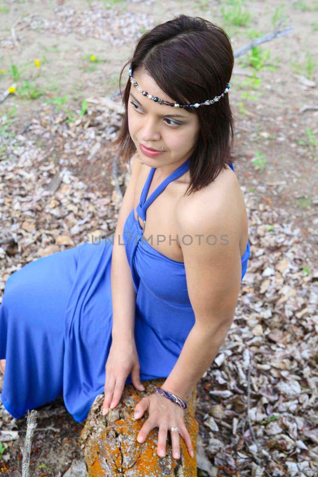 Brunette female wearing a blue dress outdoors 