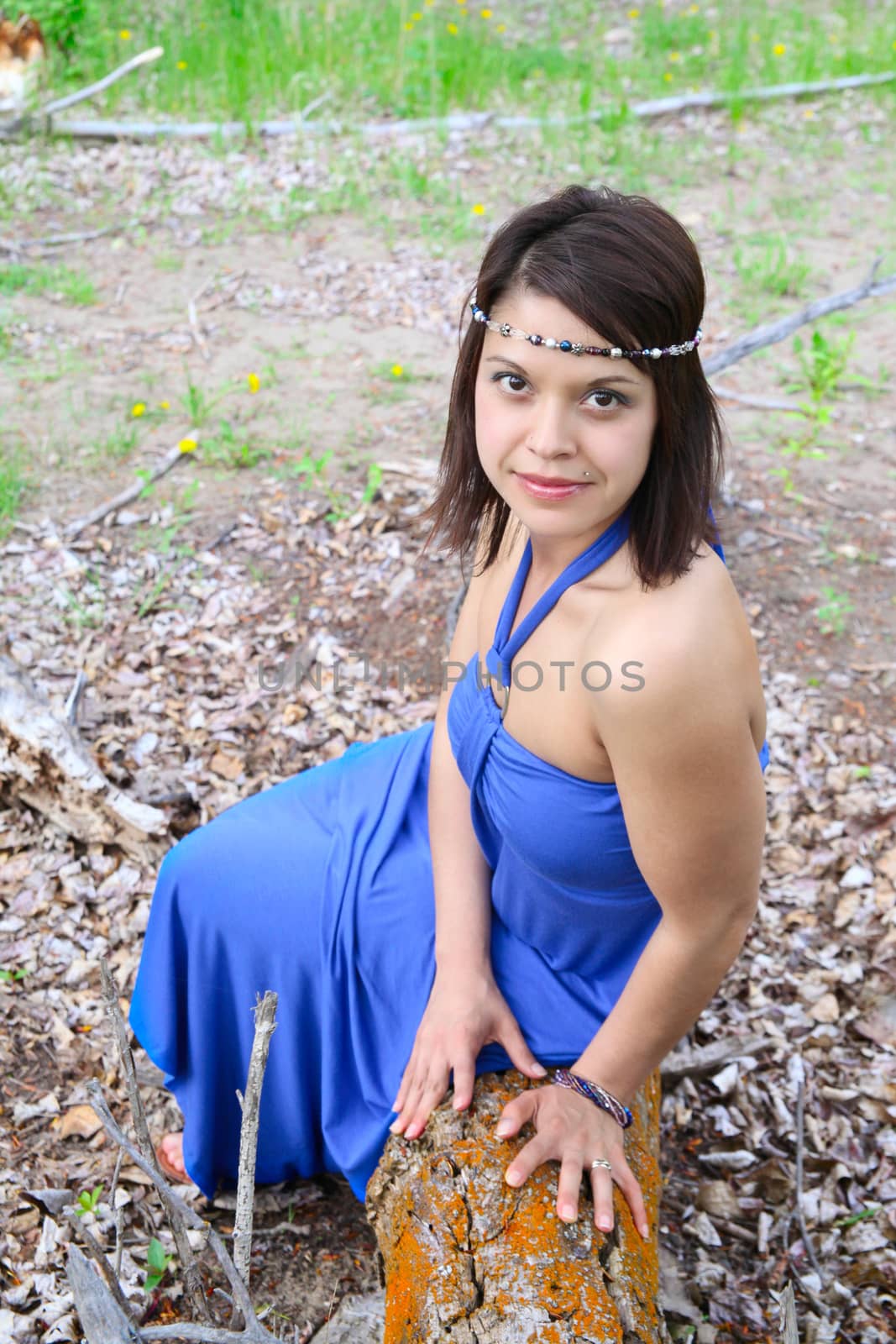 Brunette female wearing a blue dress outdoors 
