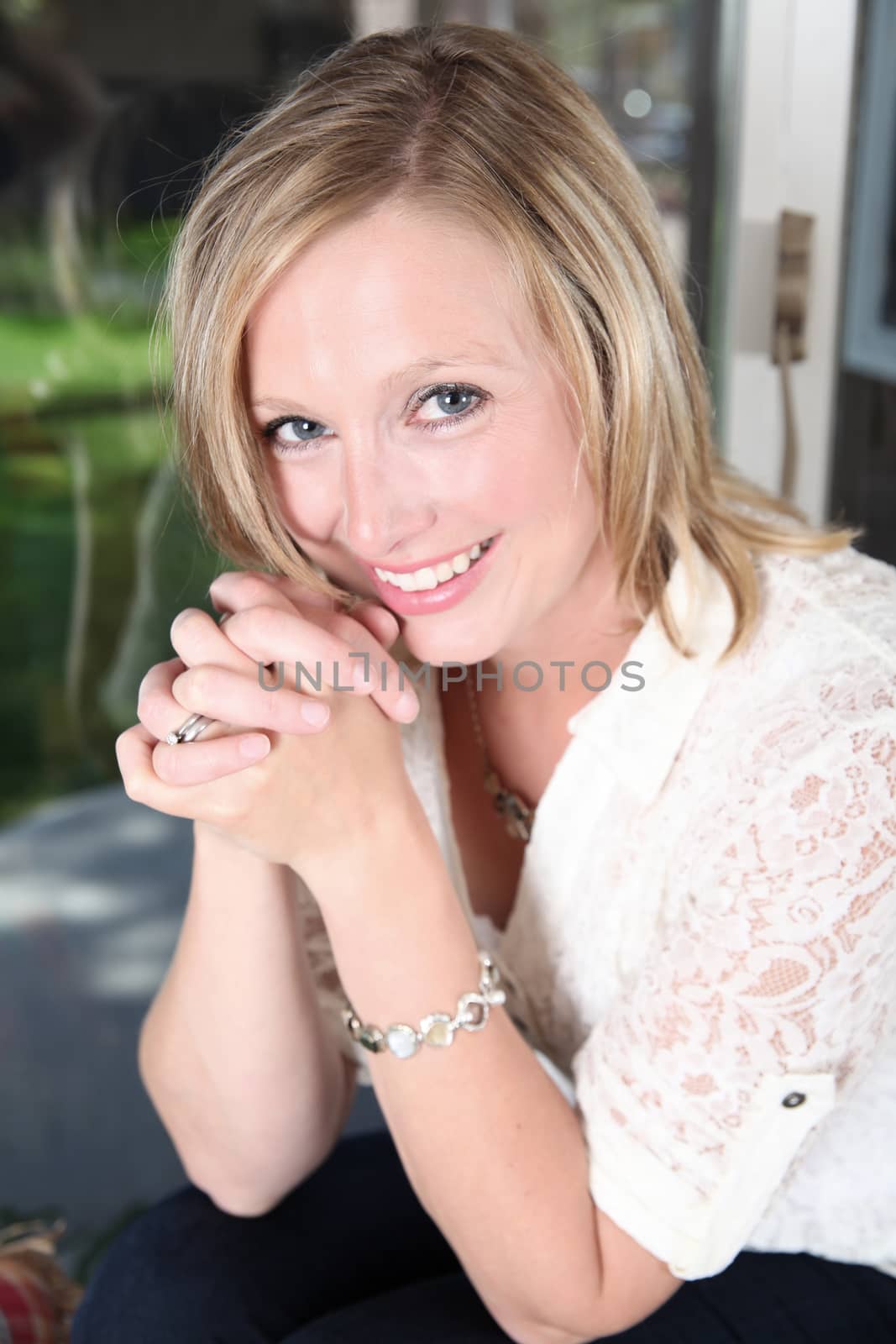 Portrait shot of beautiful blond woman against a window