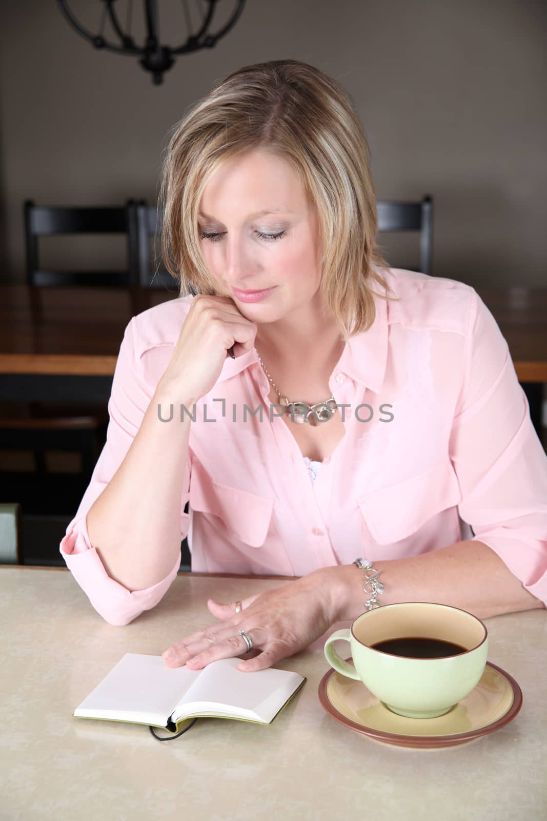 Beautiful blond female looking at empty pages