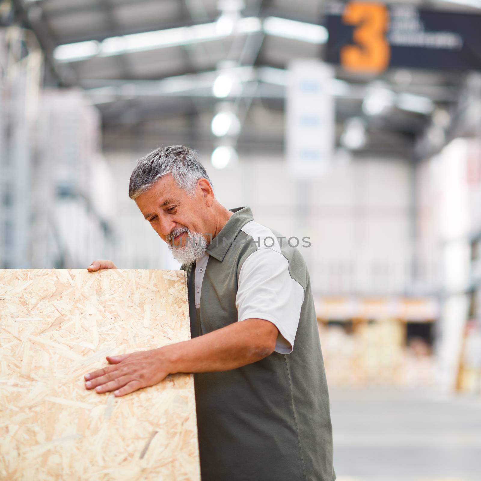 Man buying construction wood in a  DIY store for his DIY home re-modeling project