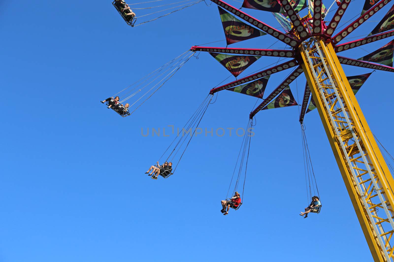 Coquitlam BC Canada - April 13 2014 : Flying swing carousel against blue sky in Coquitlam BC Canada. 