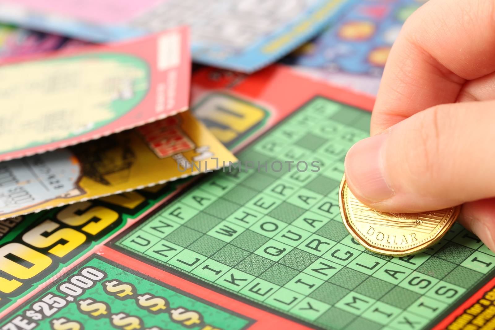 Coquitlam BC Canada - May 25, 2014 : Scratching lottery tickets. The British Columbia Lottery Corporation has provided government sanctioned lottery games in British Columbia since 1985. 