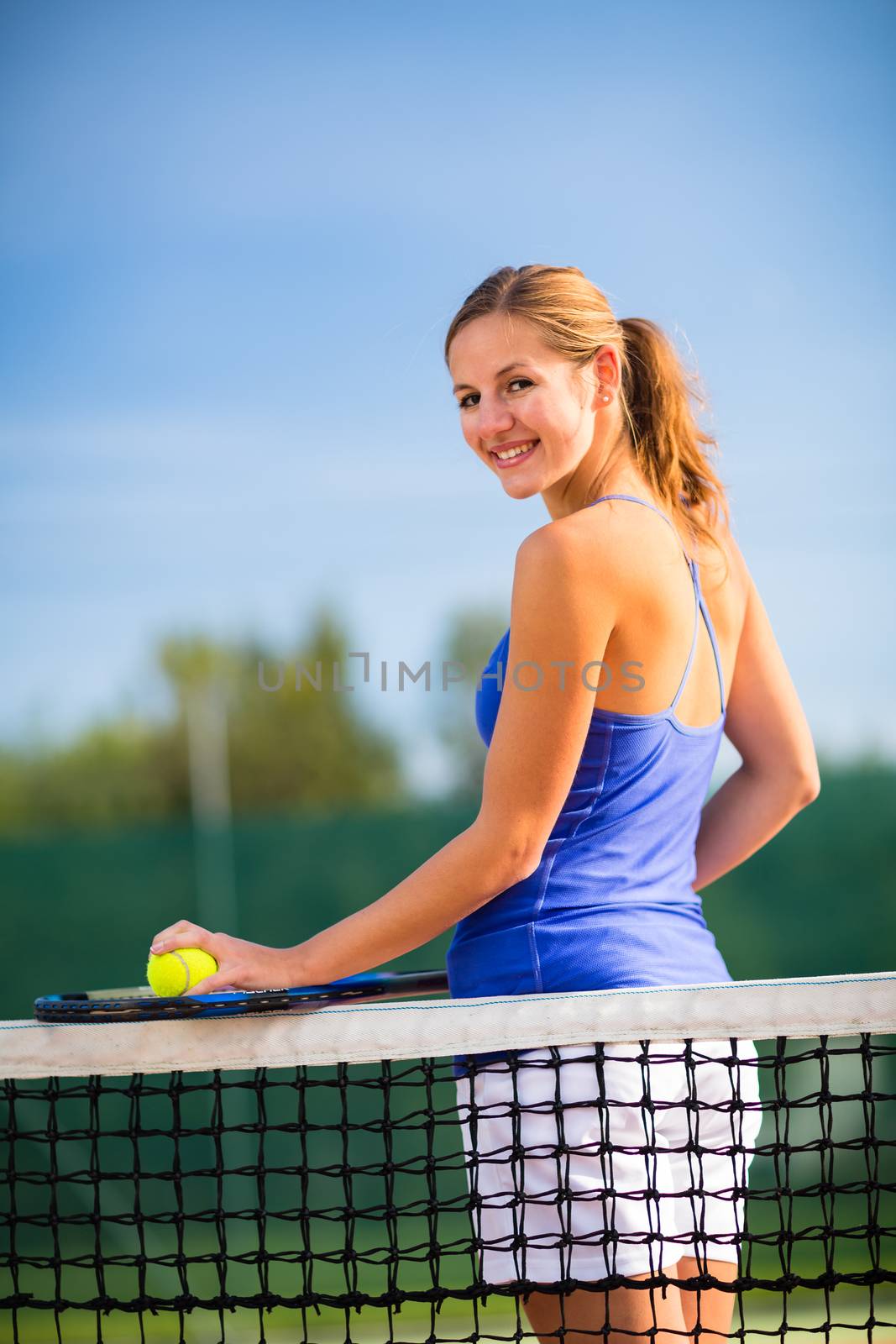 Portrait of a pretty, young tennis player  on  a court by viktor_cap