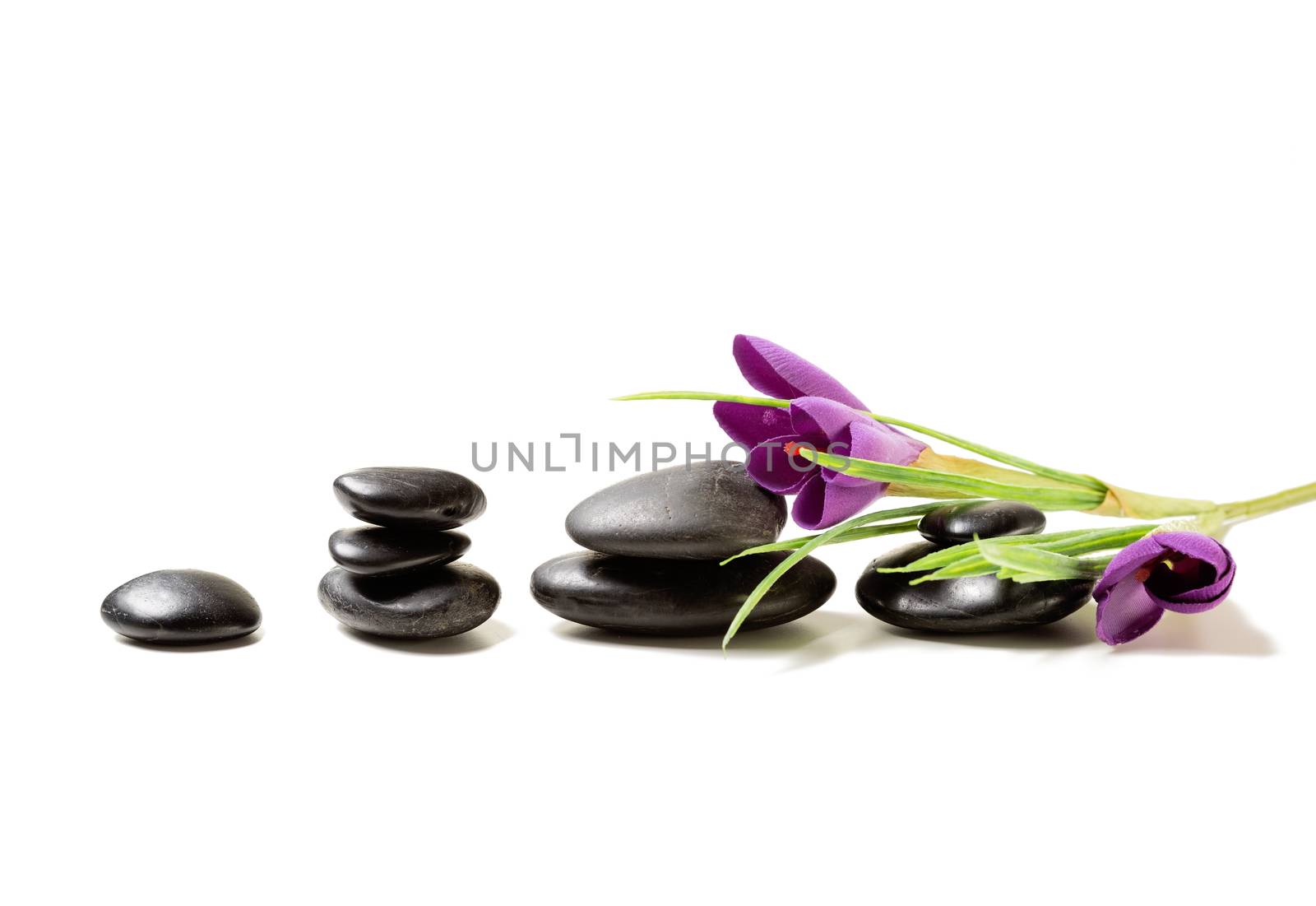 massage stones with flowers on mat by dolgachov