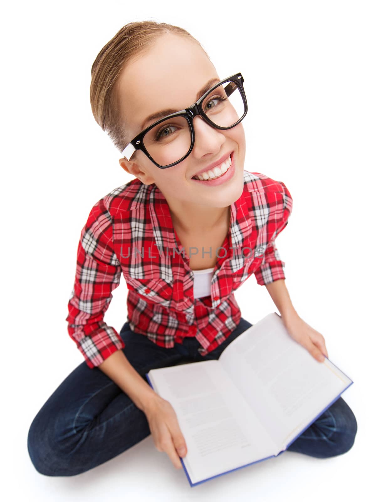 education and leisure concept - smiling teenage girl in black eyeglasses reading book