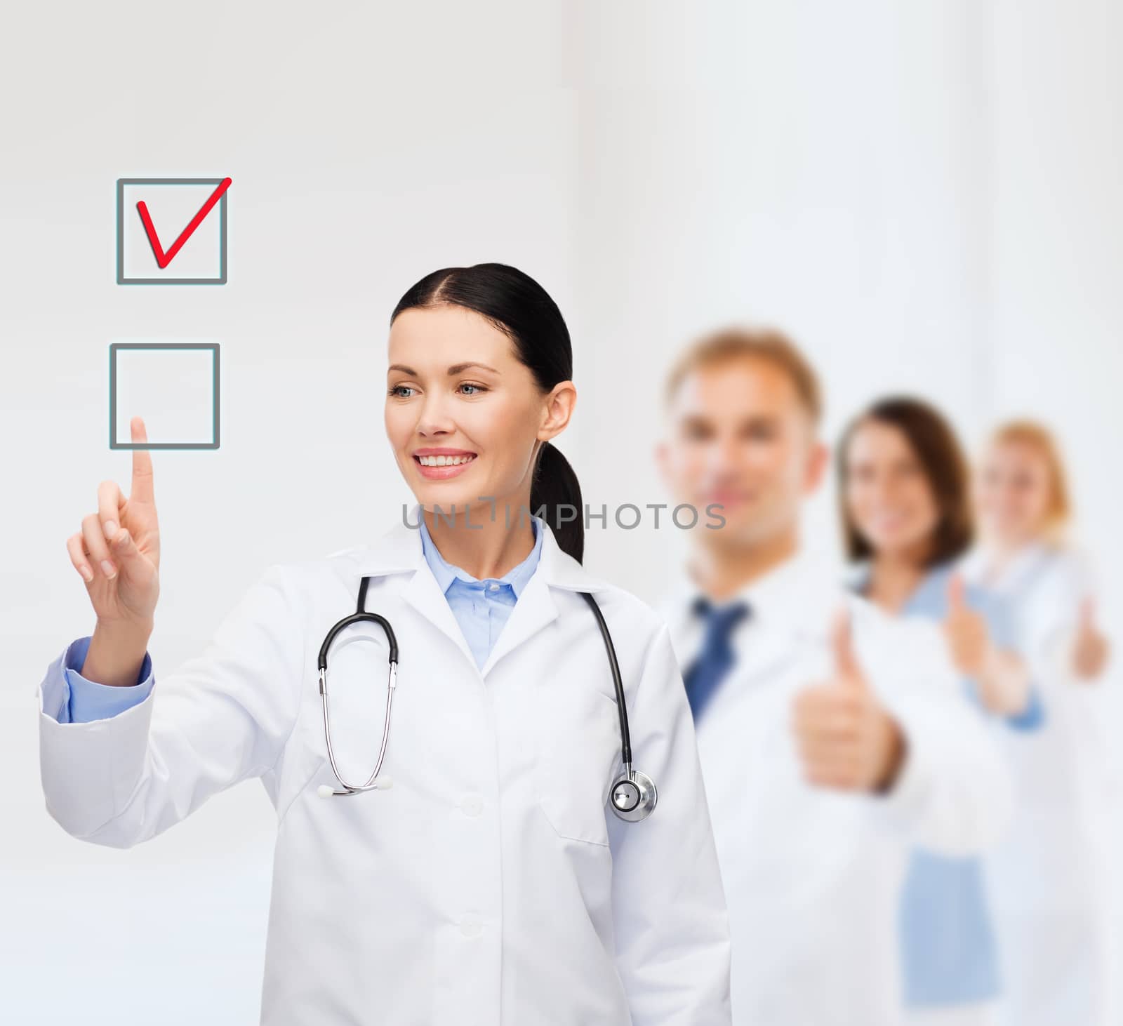 healthcare, medicine and technology concept - smiling female doctor pointing to checkbox