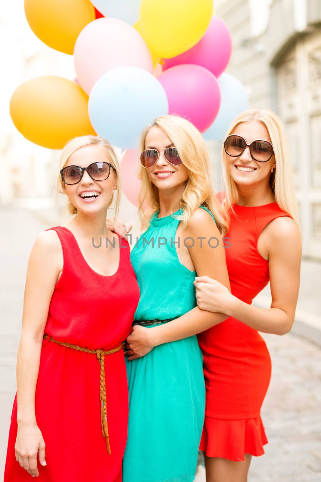 beautiful girls with colorful balloons in the city by dolgachov