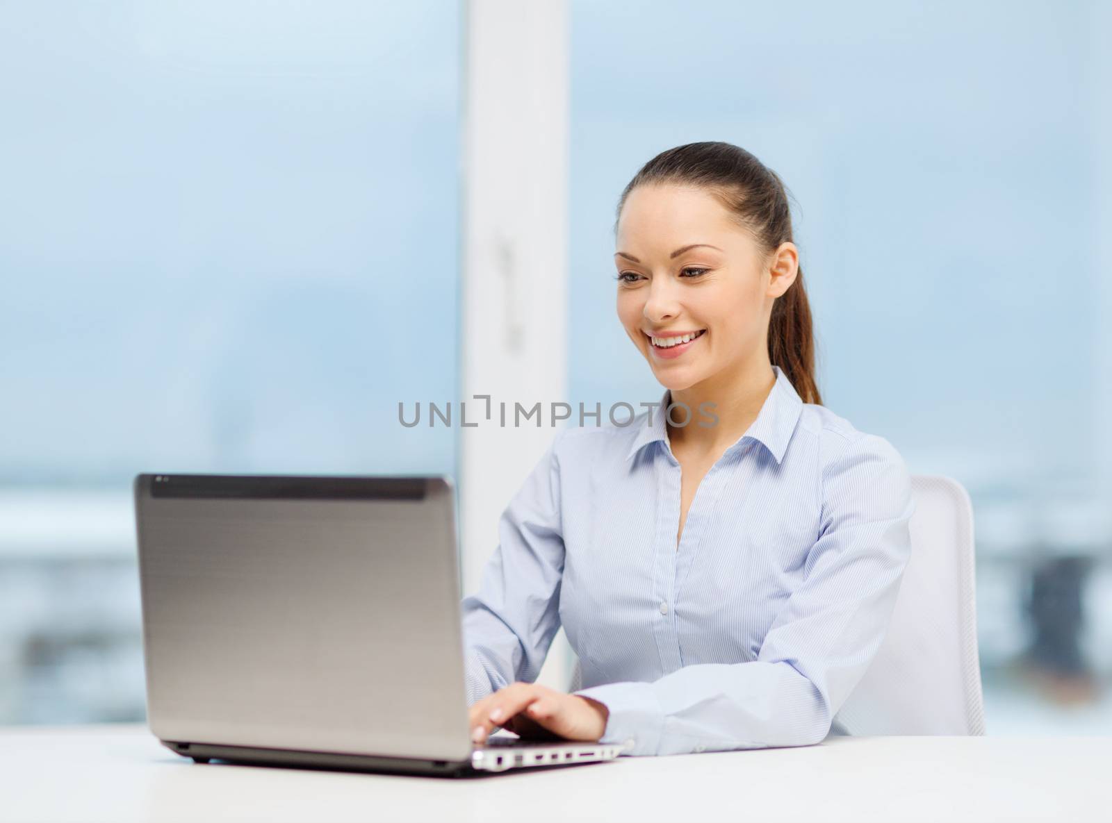 businesswoman with laptop in office by dolgachov