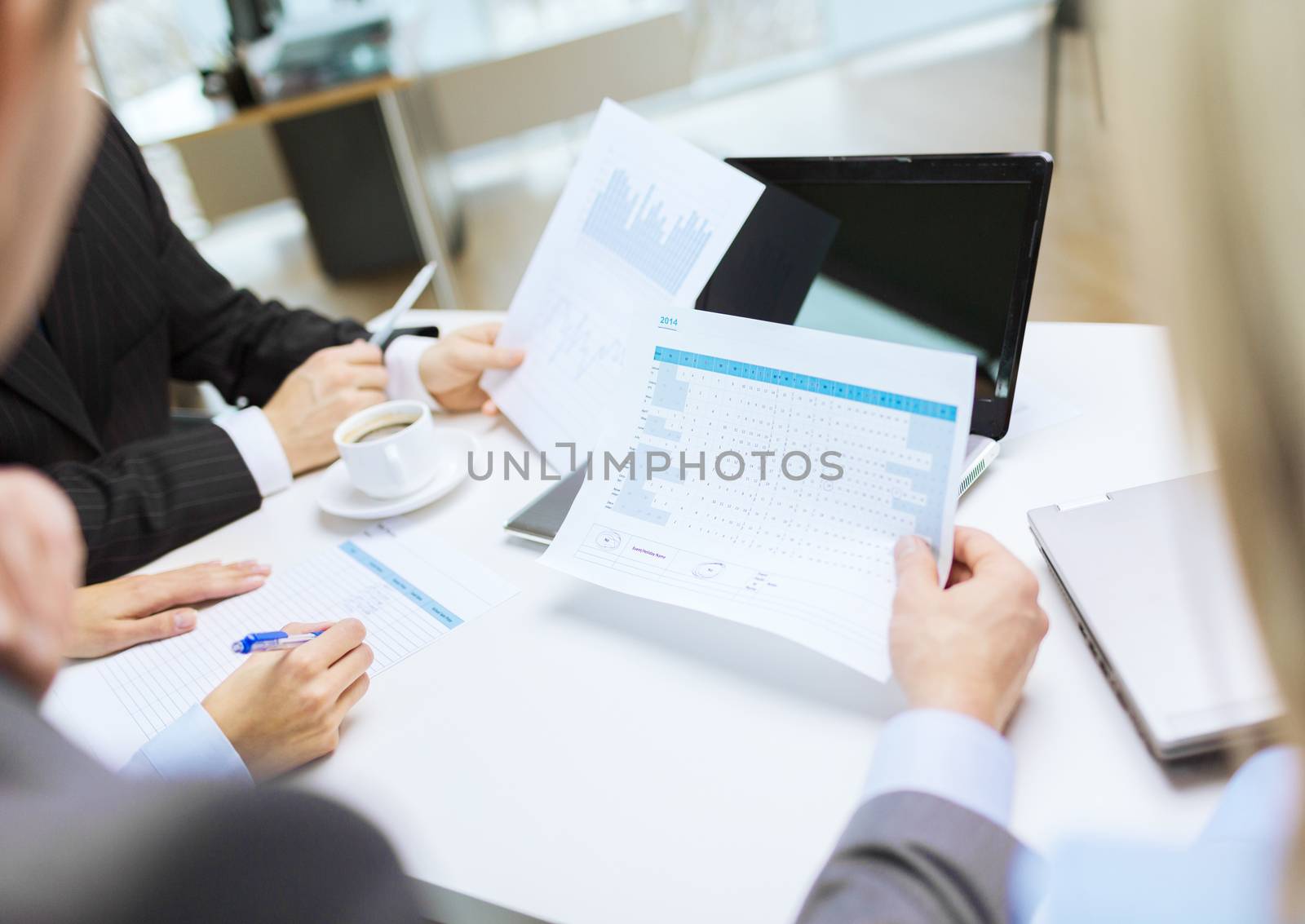 close up of files and laptop computer in office by dolgachov