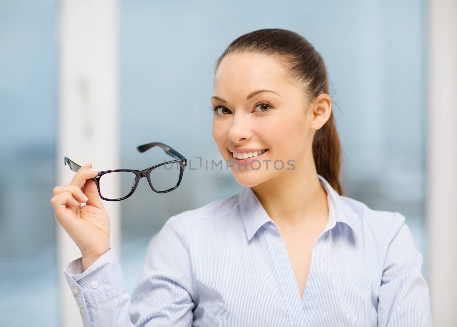 business and education concept - laughing businesswoman with eyeglasses