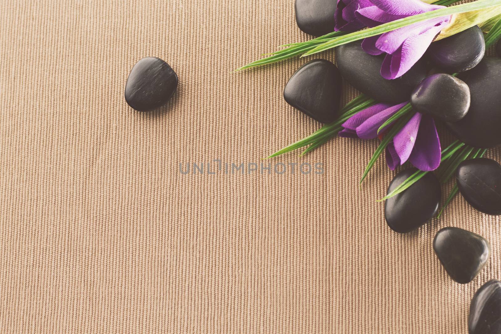 massage stones with flowers on mat by dolgachov