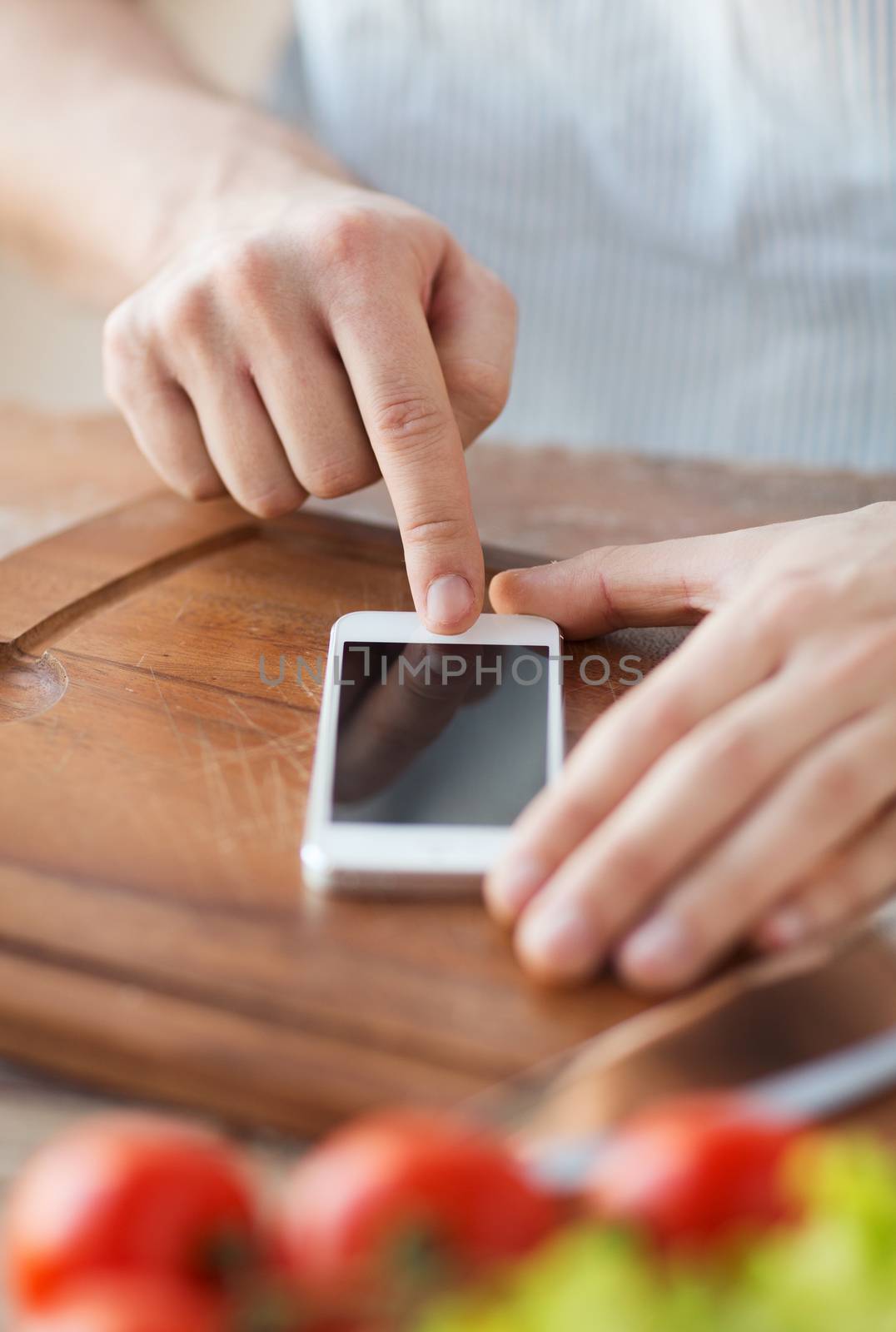 closeup of man pointing finger to smartphone by dolgachov