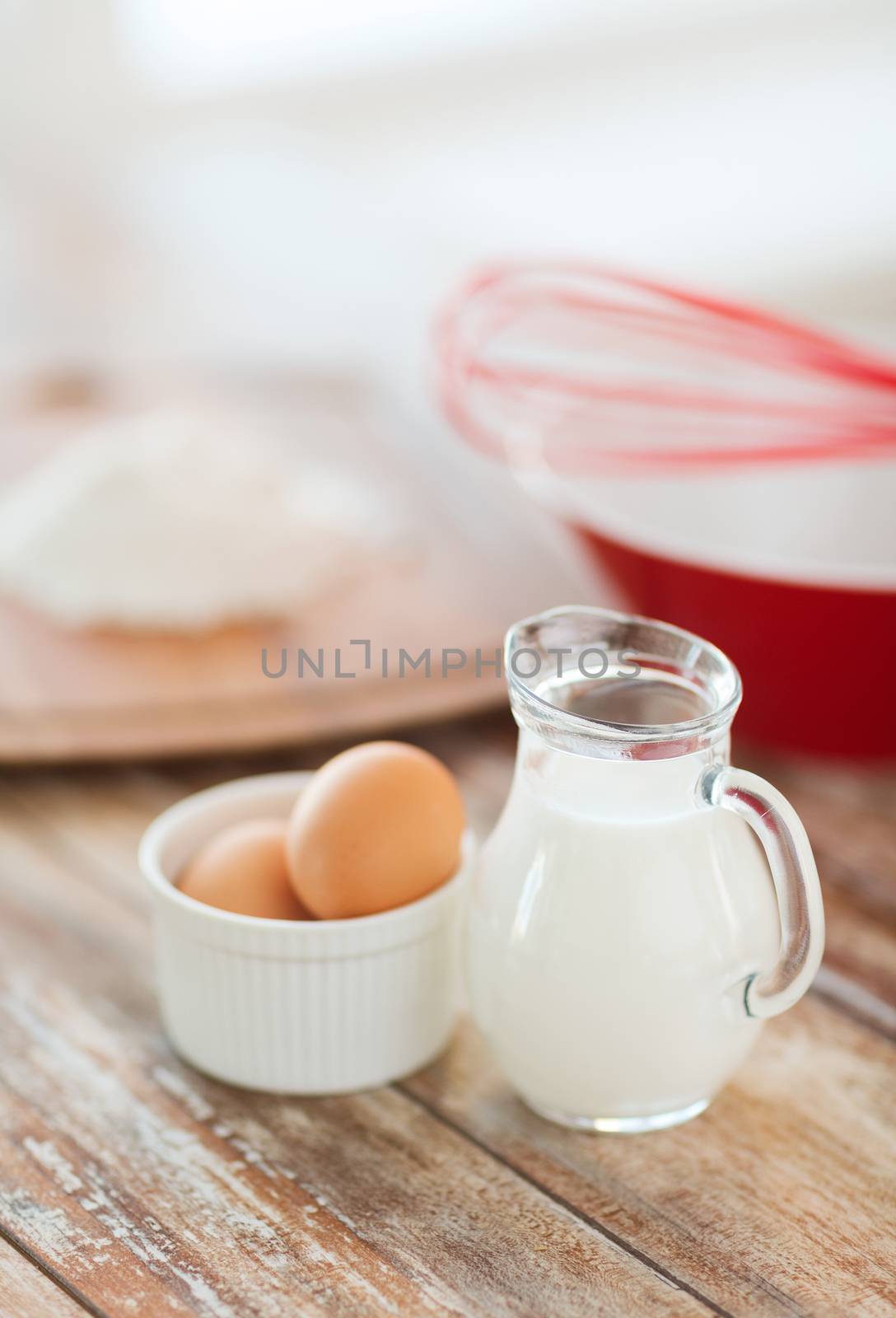 jugful of milk, eggs in a bowl and flour by dolgachov