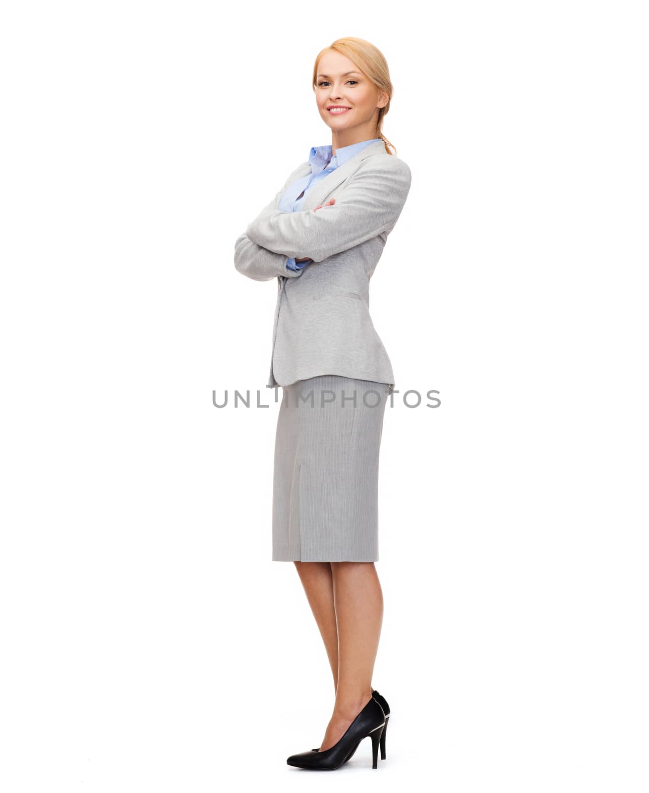 smiling businesswoman with crossed arms by dolgachov