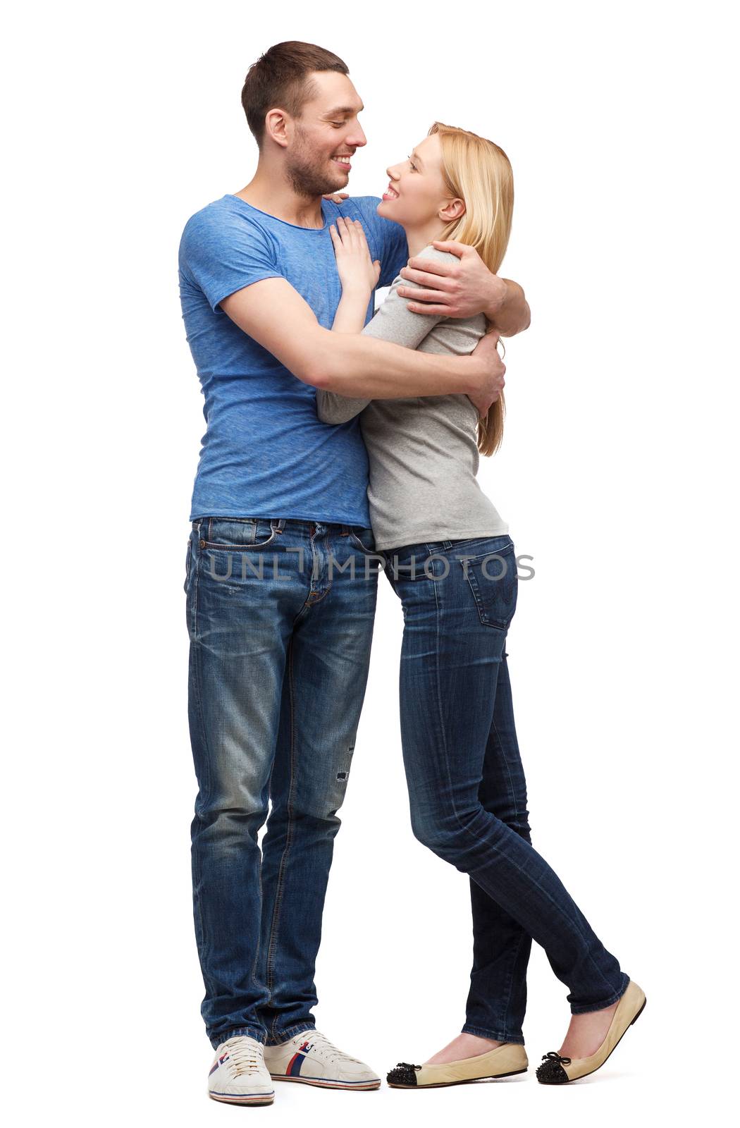 love and family concept - smiling couple hugging and looking at each other