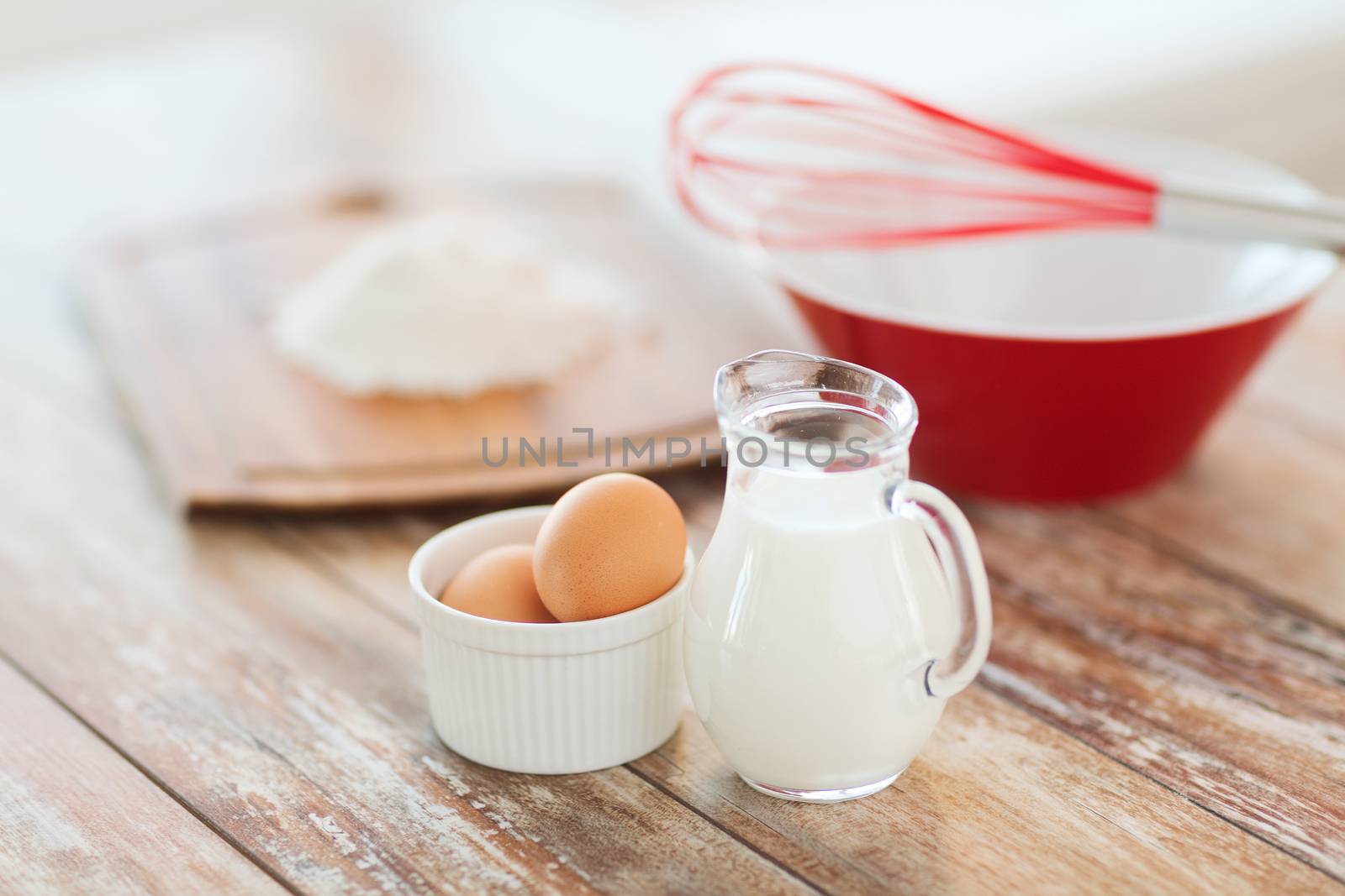 jugful of milk, eggs in a bowl and flour by dolgachov