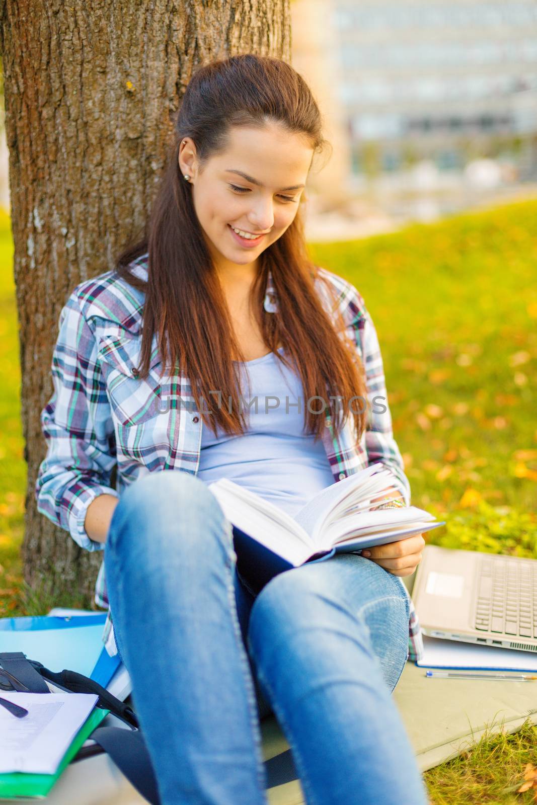 smiling teenager reading book by dolgachov