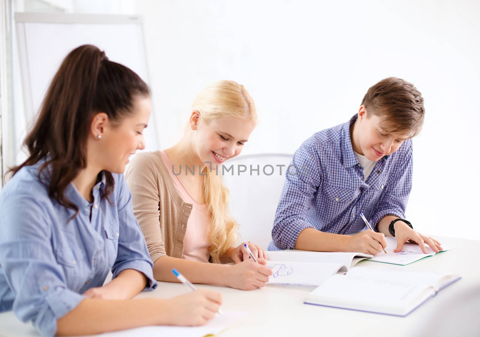 school and education concept - group of smiling students with notebooks at school