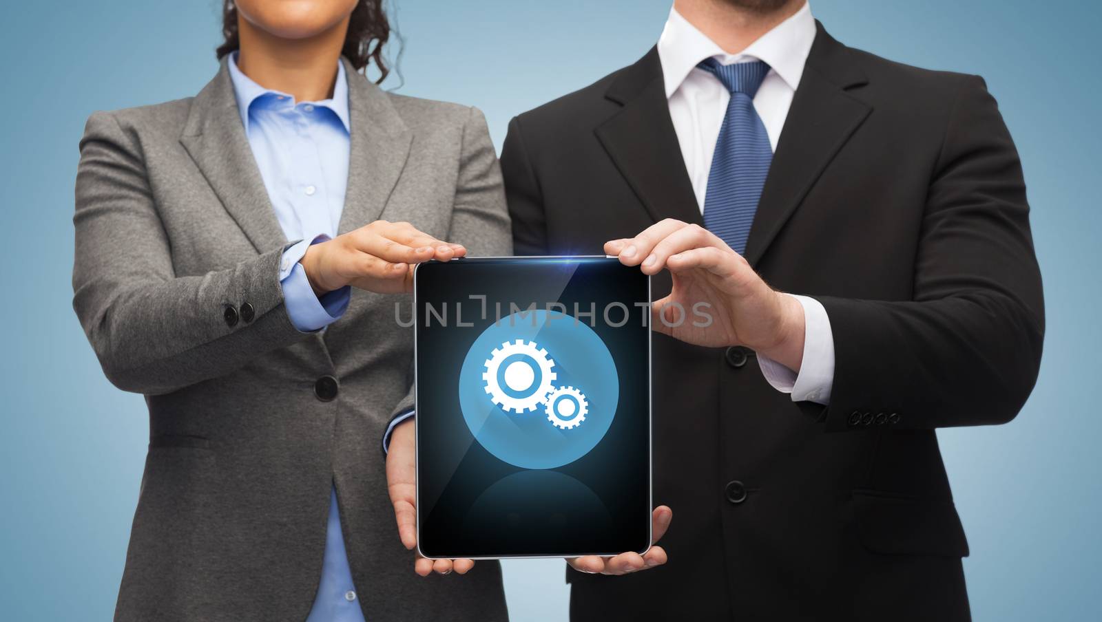 businessman and businesswoman with tablet pc by dolgachov