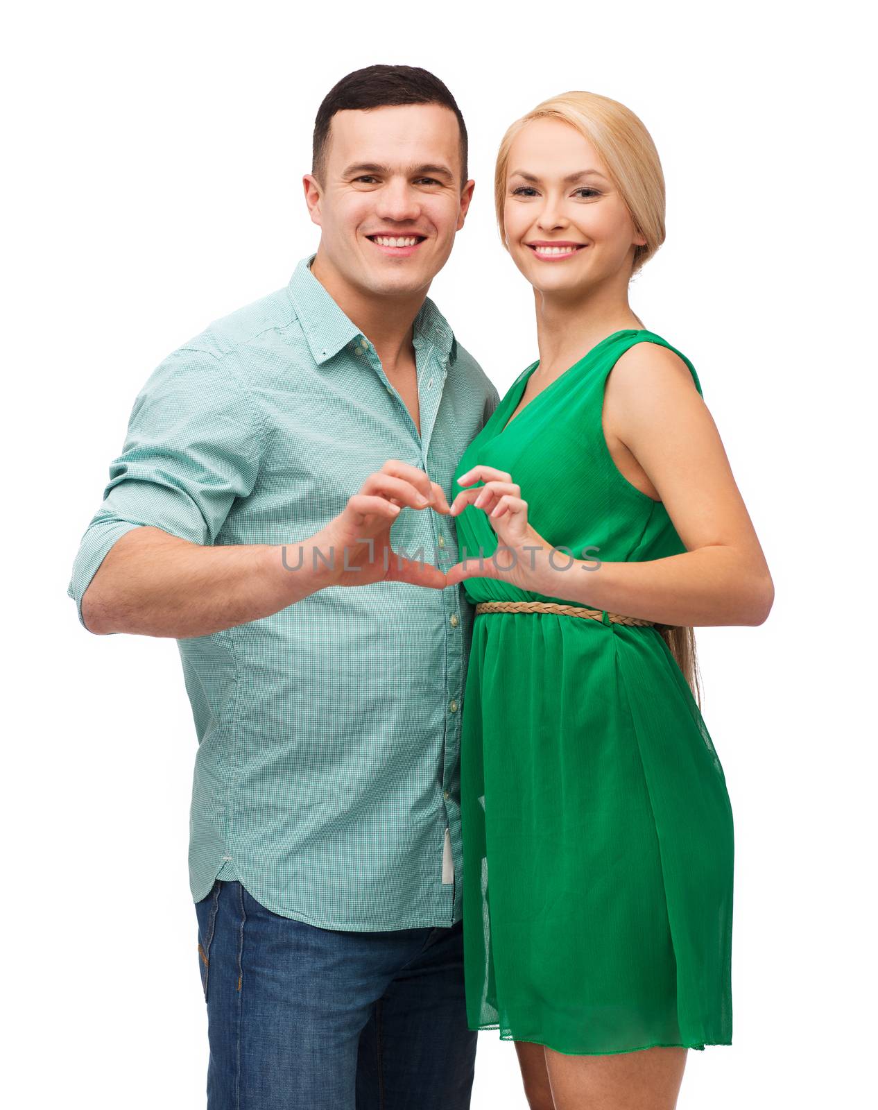 smiling couple showing heart with hands by dolgachov