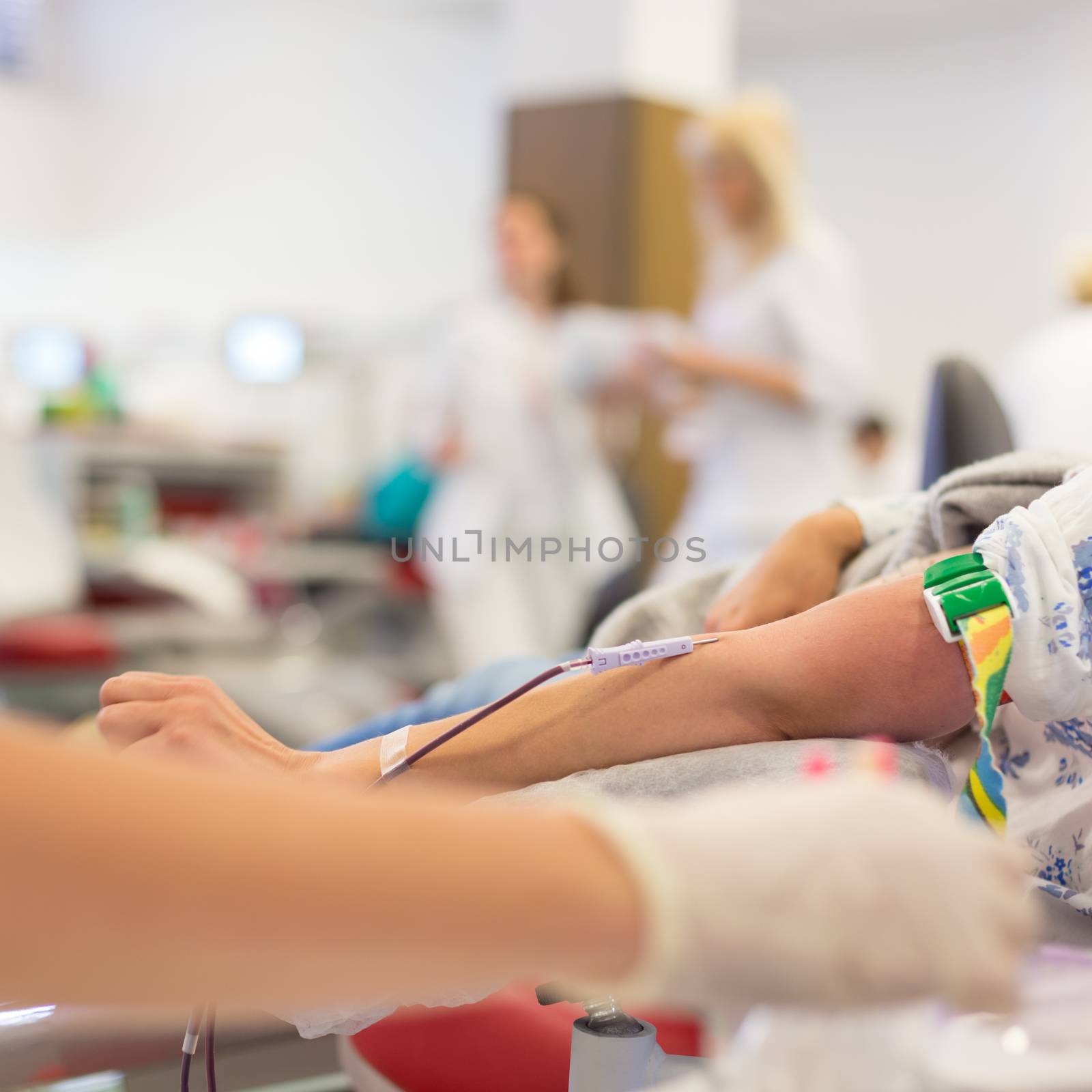 Role of nurses in blood services and donor sessions.  Nurse and blood donor at donation.