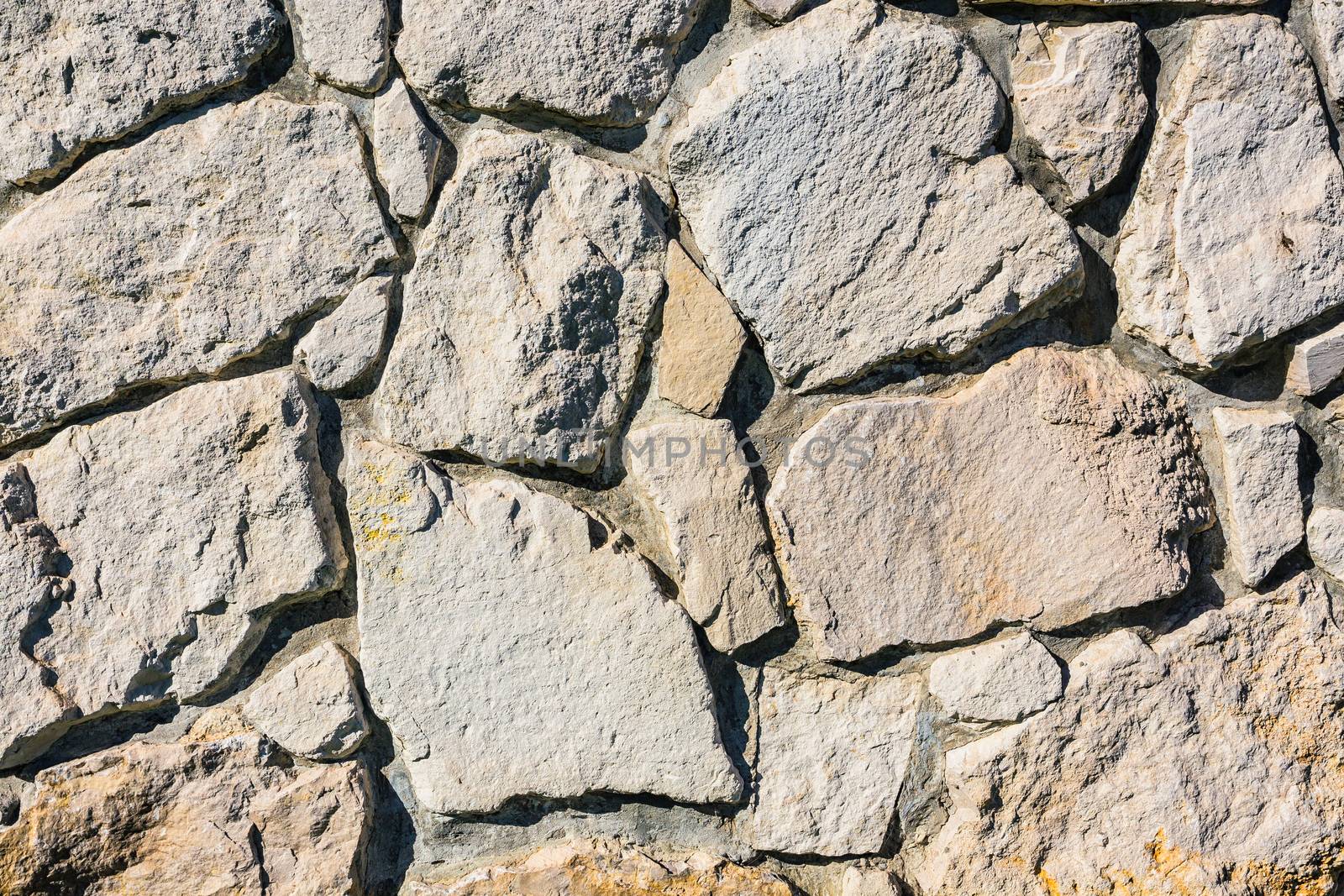 Old stone brick wall fragment as a background texture