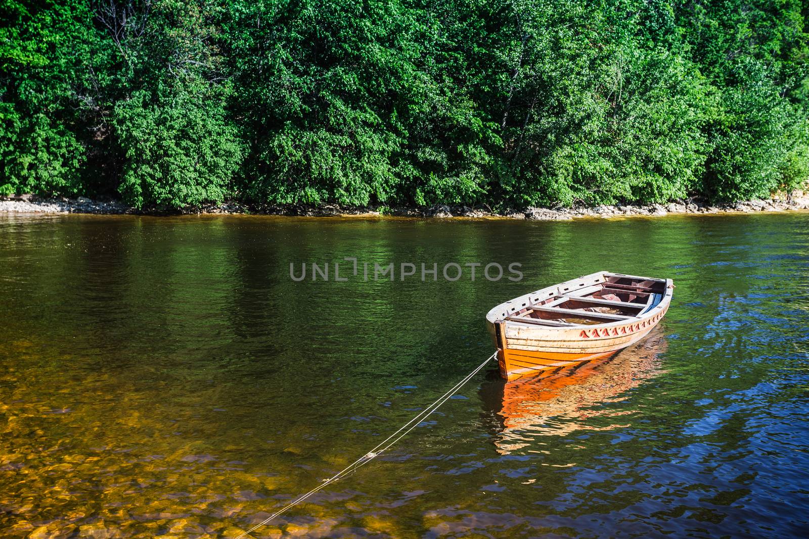 wooden boat on the river bank by oleg_zhukov