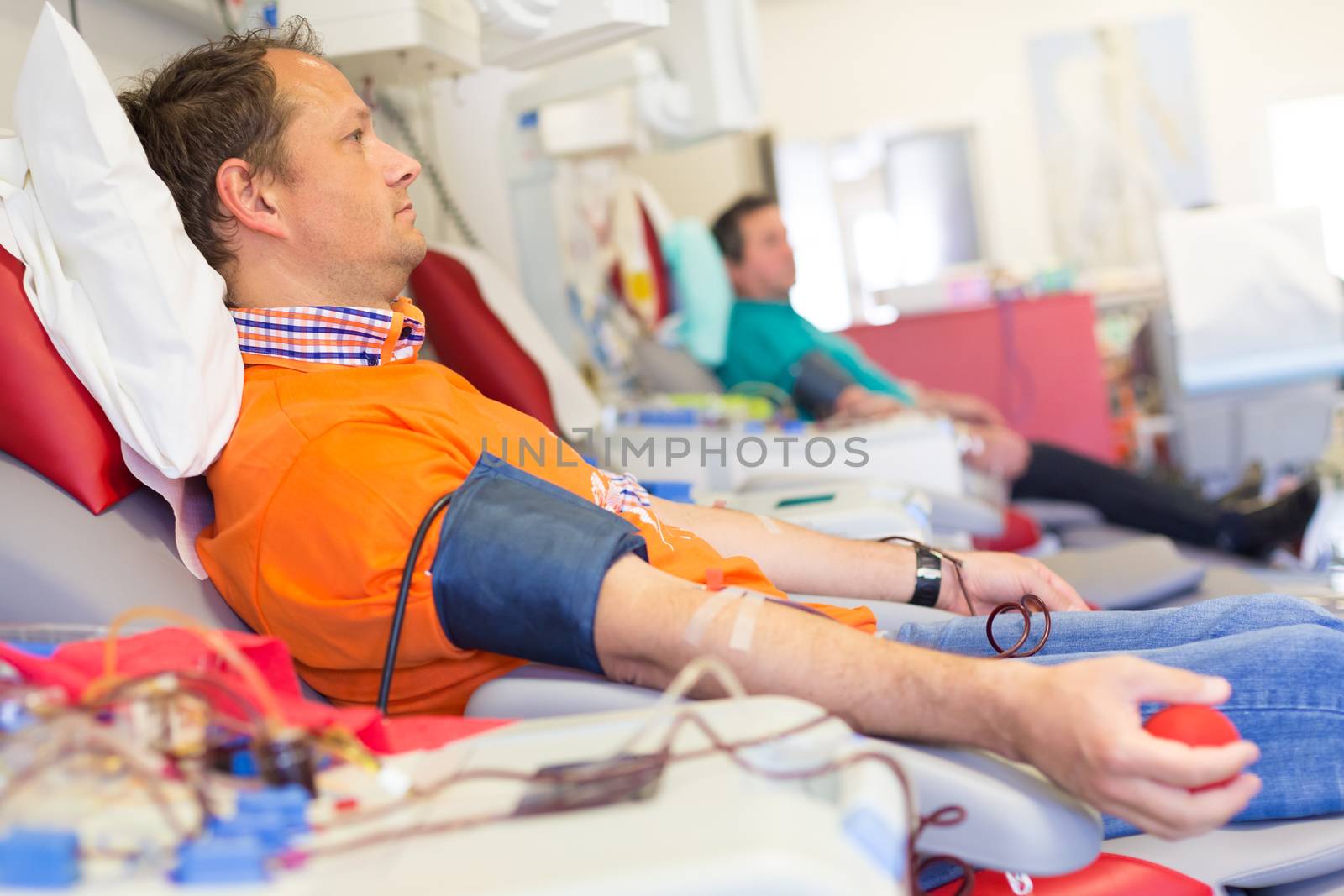 Blood donor at donation with a bouncy ball holding in hand.