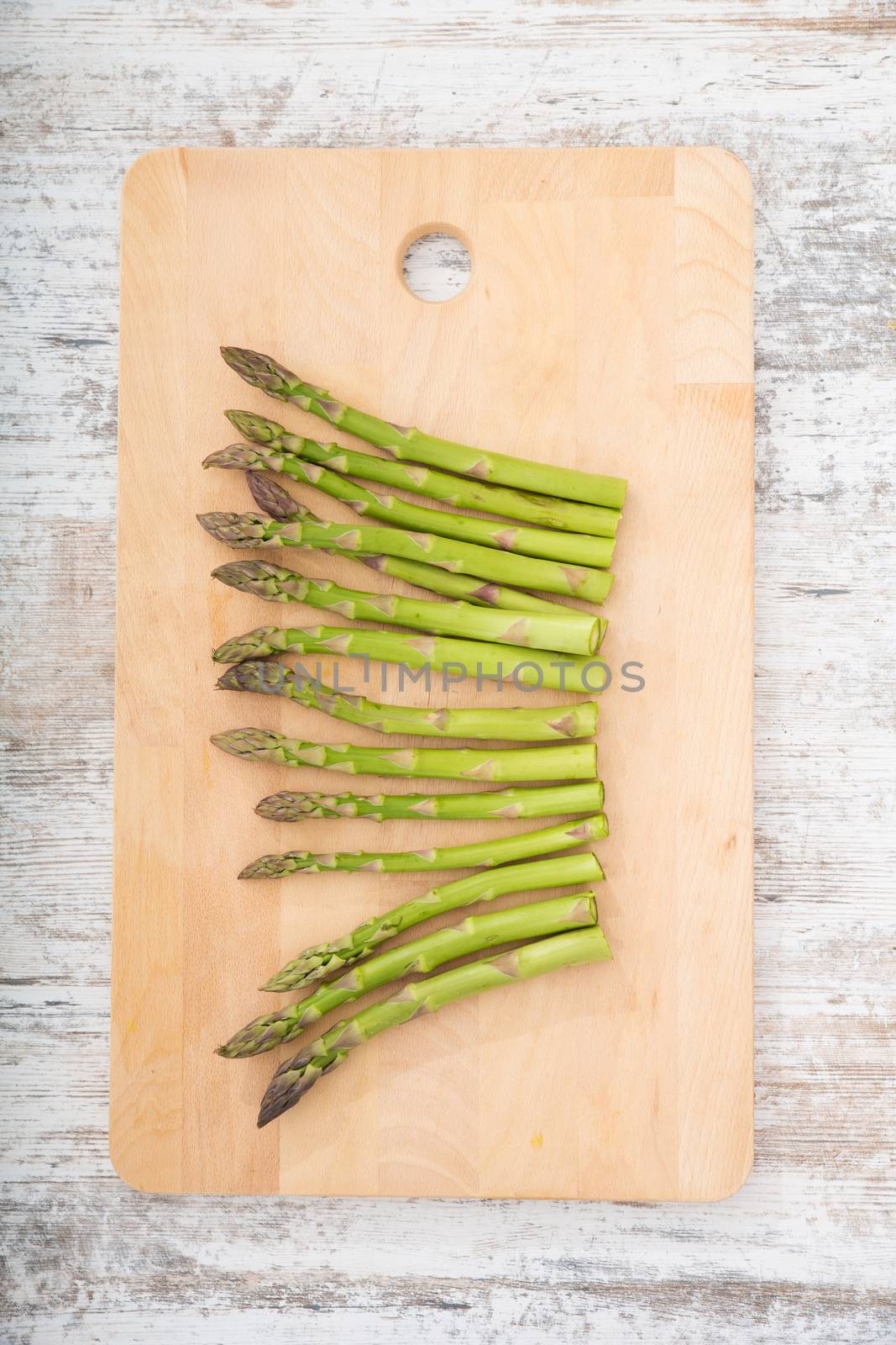 Fresh Asparagus on a wooden tablet.