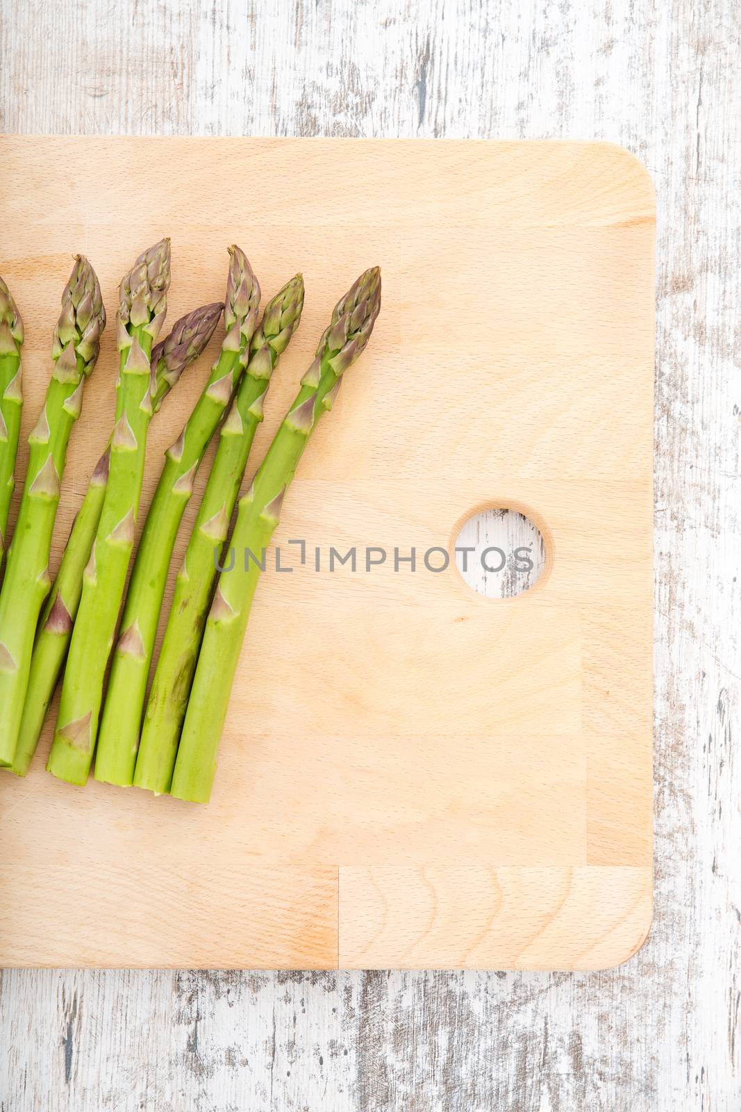Fresh Asparagus on a wooden tablet.