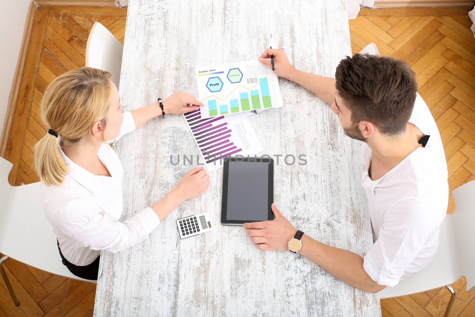 A young couple organizing their financial situation at home.