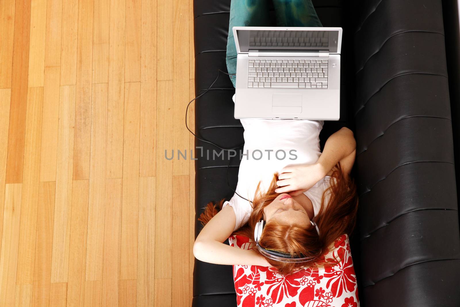 A young woman surfing on the Internet with a Laptop.  