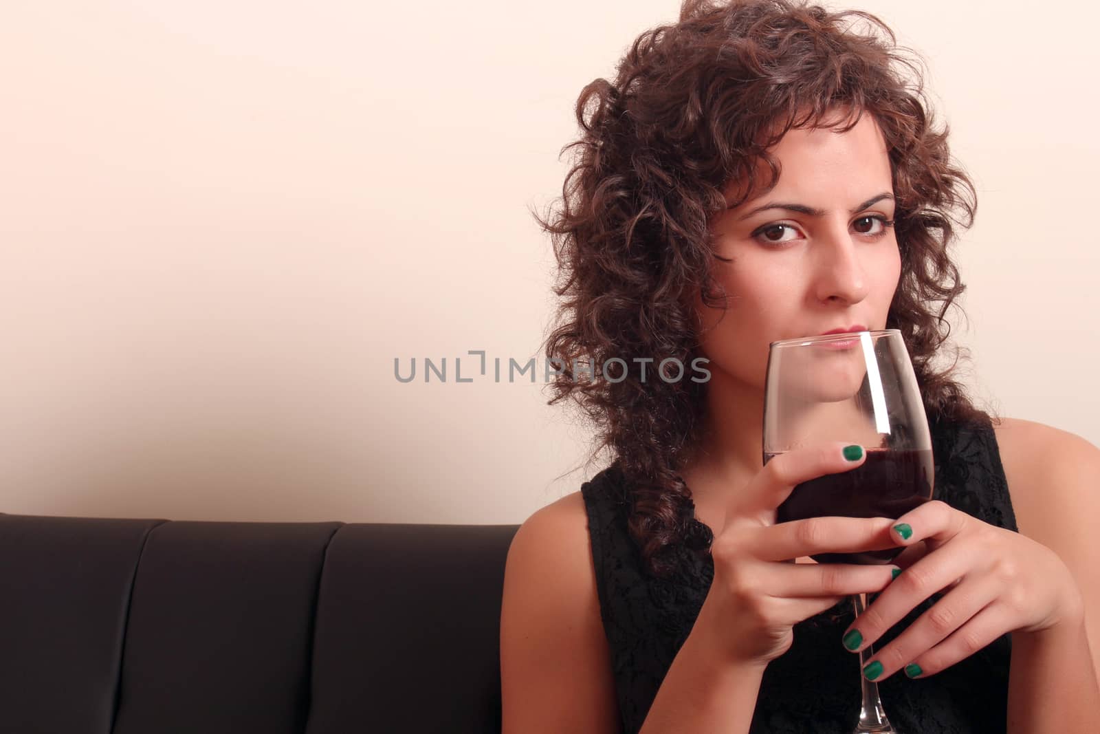 Portrait of a beautiful, latin Woman drinking red wine.