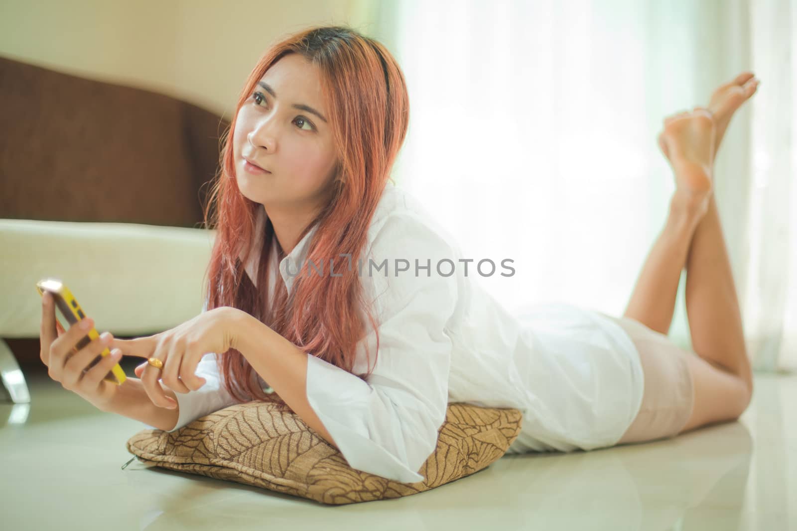 young woman using smart phone by witthaya